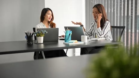 A group of people reviews a report on optimising customer relations.